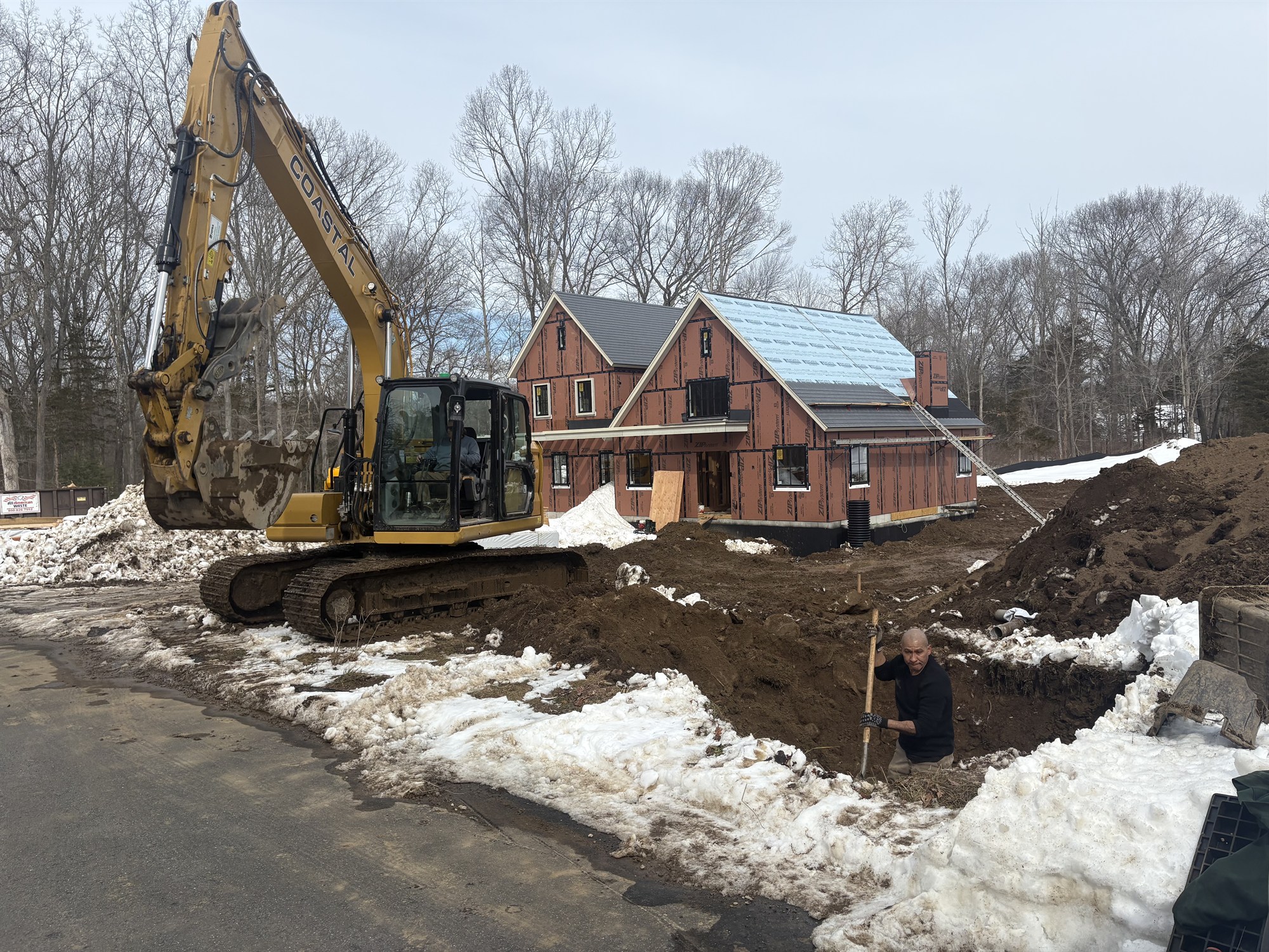 CLH excavator running drainage and utility work in winter